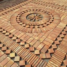 a circular design made out of bricks on the ground