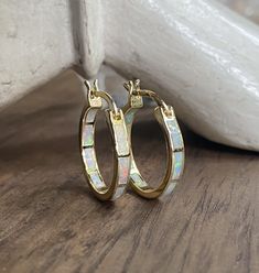 The perfect hoops for everyone, everyday, all day! These comfortable little beauties will take you from day to night and look great dressed down but fit in to formal events with ease. Super fiery opals are inlaid into these darling little 14k gold plated classic hoops. Hoops measure 20 mm and are 3mm thick. In inches these are about 3/4" hoops.*Perfect for bridesmaids*These arrive ready for gifting in a cute, boho gift box Elegant Opal Huggie Earrings, Elegant Opal Huggie Jewelry, Elegant Opal Hoop Earrings, Elegant Gold Opal Hoop Earrings, Gold Opal Small Hoop Earrings, Small Gold Hoop Earrings With Opal, Opal Stud Earrings, Opal Earrings Stud, Birthstone Earrings