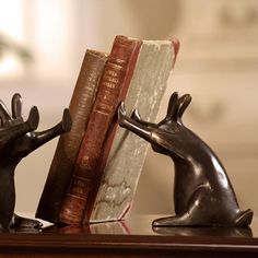 two bookends made to look like antlers with books on them sitting next to each other