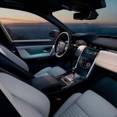 the interior of a car with white and black leather