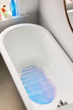 a white bath tub sitting next to a window