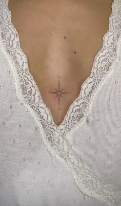 a woman with a small star tattoo on her back neck and lower back ribcage