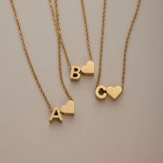 Spell it out. The traditional initial necklace gets an elegant upgrade with a simple heart symbol - no chain stack is complete without it.Made with waterproof stainless steel, you never need to worry about fading or tarnishing jewelry ever again. Waterproof & tarnish-free Stainless steel 14K gold-plated Length: 17.7in (+ 3in adjustable) Hypoallergenic, lead & nickel free If you aren't in LOVE with your purchase, please let us know within 30 days of receiving your item, and you'll receive a stress-free refund. Everyday Letter Jewelry For Mother's Day, Everyday Stainless Steel Necklace For Mother's Day, Trendy Initials Jewelry For Mother's Day, Stainless Steel Charm Necklaces For Mother's Day, Trendy Letter-shaped Jewelry For Gifts, Everyday Stainless Steel Charm Necklaces For Mother's Day, Everyday Stainless Steel Charm Necklace For Mother's Day, Mother's Day Stainless Steel Charm Necklace, Minimalist Stainless Steel Jewelry For Mother's Day