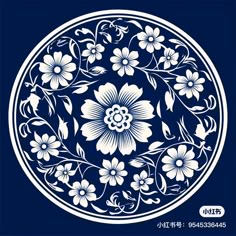 a blue and white plate with flowers on it's side, in the shape of a circle