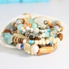 "Woman's Beachy Boho Anchor Bracelet, Fun Surf & Sea Eclectic Bracelet! Tropical Boho Maritime Stack ANCHOR BRACELET, ♥Beautiful Summer Themed Bracelets for stacking, I use a variety of materials you would find strolling along a warm sandy beach, so to capture this feeling I used Sea Glass, Shell, Gemstones, Jade, White Wood, Ceramic, and Silver Spacers, Jewelers Stretch Cord. The maritime symbol of the anchor represents truth, stability and hope. Let the truth guide you as you navigate the Bohemian Letter Beads Beaded Bracelets For Beach, Bohemian Adjustable Stretch Bracelet For Beach Season, Adjustable Bohemian Bracelet For Beach Season, Bohemian Beach Beaded Bracelets With Letter Beads, Bohemian Jewelry With Letter Beads For Beach Season, Bohemian Beaded Bracelets With Letter Beads For Beach, Beachy Beaded Stretch Bracelet For Beach, Colorful Beaded Bracelets For Vacation And Beach Season, Colorful Beaded Bracelets For Beach Vacation