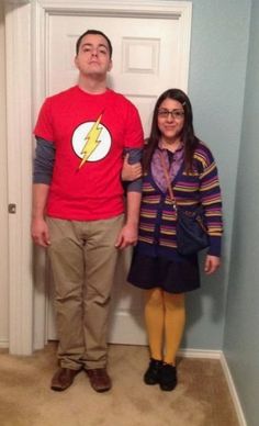 a man and woman standing in front of a door with the flash logo on it