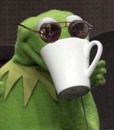 kermie the frog wearing sunglasses and holding a coffee cup