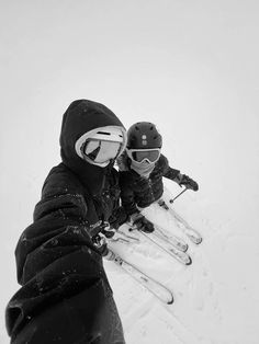 two people on skis in the snow