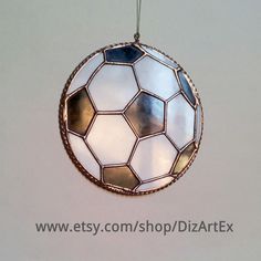 a stained glass ornament hanging from a string