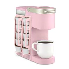 a pink coffee maker with cups in it