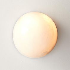 a round light fixture mounted on the wall