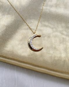 Our Rian Crescent Moon Necklace adds a touch of magic to your style! A beautiful and timeless piece, this necklace celebrates the phases of life. Show off your personality with a timeless accessory that’s bold and inspiring. Shine brighter with this special, gold necklace! DETAILS - Crafted with pure sterling silver and optional gold-plating - 16" chain with a 2" extension - Approximately 20mm tall & 15mm wide VARIATIONS If you require any variation of this style (longer chain length, etc) feel Moon Necklace Gold, Crescent Moon Necklace Gold, Nameplate Necklace, Photo Necklace, Crescent Moon Necklace, Timeless Accessories, Moon Necklace, Long Chain, Jewelry Pouch