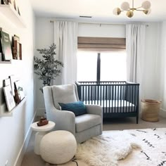 a baby's room with a crib, chair and rug