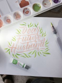 some paint and watercolors are sitting on a table next to a paper with the words dear future husband