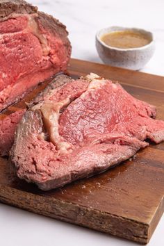 a piece of meat sitting on top of a wooden cutting board