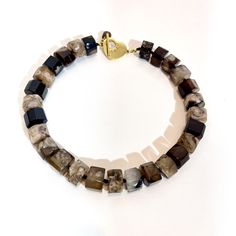 A combination of natural brown and cream colors in each stone.  A wheel shape beads to display the beauty of the agate stone.   Agates are clusters of tiny quartz that share similar components, like hardness and color. This necklace measures 18 inches long and weighs 9 ounces. The color is rich and easy to wear. Resin And Clay, Agate Necklace, Natural Brown, Agate Stone, Rich Color, Semiprecious Stones, Cream Color, Jewelry Collection, Agate