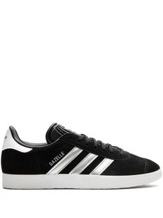 black suede signature 3-Stripes logo contrasting heel counter round toe front lace-up fastening logo-debossed tongue branded insole rubber sole These styles are supplied by a premium sneaker marketplace. Stocking only the most sought-after footwear, they source and curate some of the most hard to find sneakers from around the world. Adidas Gazelle Black, Silver Sneakers, Style Muse, Adidas Gazelle, Personal Shopper, Black Adidas, Sneakers Black, Black Suede, Black Silver