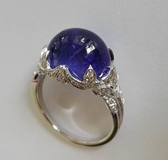 Dalben Tanzanite Diamond Gold Ring | From a unique collection of vintage cocktail rings at https://www.1stdibs.com/jewelry/rings/cocktail-rings/ Luxury Hallmarked Oval Cabochon Sapphire Ring, Luxury Cabochon Diamond Ring For Formal Occasions, Luxury Formal Cabochon Diamond Ring, Sapphire Cabochon Diamond Ring, Sapphire Oval Cabochon Ring With Diamonds, Elegant Sapphire And Diamond Ring With Cabochon Cut, Elegant Sapphire Ring With Cabochon Diamond, Formal Polished Finish Oval Cabochon Sapphire Ring, Luxury Oval Sapphire Ring With Polished Finish