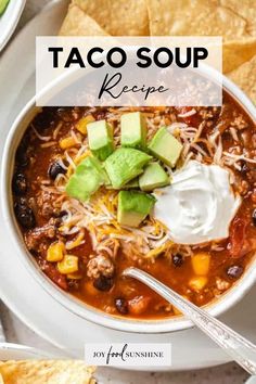 a bowl of taco soup with tortilla chips and sour cream on the side