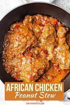 the african chicken is cooked in a skillet with red peppers and sauce on top