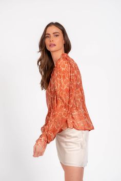 Adorned with a stunning warm rust print, this top exudes luxury and elegance. Perfect for any occasion, this top will elevate your style with its beautiful design. Materials: 99% Rayon, 1% Metalic Sizes: XS, S, M, L Dry Clean only Color: Rust Multi Model size S Made in the USA Style: BNT7916P53 Black Dress Jacket, Maxi Dress Sale, Jumpsuit Shorts Rompers, Its Beautiful, Short Rompers, New Arrival Dress, Mini Black Dress, Skirt Pants, Sweater Jacket