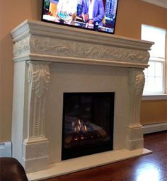 a flat screen tv mounted on top of a fireplace