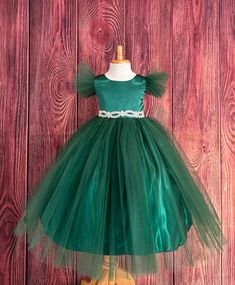 This beautiful elegant dress is one of my favorite! So modern and classy for any special occasion. Bodice is made of Hunter Green satin followed by fluffy Hunter Green tulle sleeves, waistline consists of a rhinestone band (not removable) a hidden zipper can be found in the back of the dress. The skirt consist of 2 Hunter Green Tulle layers, a layer of Hunter Green satin followed by lining with crinoline for fullness. Dress is pictured with Petticoat to show full detail. NOT INCLUDED https://www.etsy.com/listing/1305138635/white-petticoat-wedding-bridesmaids?click_key=c98dd4420cf3925879eead78fd2d73c6223871f5%3A1305138635&click_sum=37390cf8&ref=shop_home_active_3&crt=1 Visit our store, more items to come!  https://www.etsy.com/shop/LittledarlnBoutique?ref=profile_header CUSTOM MEASUREMENTS Holiday Princess Ball Gown For Fancy Dress, Princess Ball Gown For Holiday Fancy Dress, Holiday Princess Ball Gown In Tulle, Holiday Princess Dress Ball Gown, Princess Ball Gown Bridesmaid Dress For Pageant, Princess Style Bridesmaid Ball Gown, Princess Ball Gown For Bridesmaid Pageant, Elegant Tulle Wedding Holiday Dress, Elegant Wedding Holiday Dress In Tulle