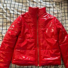 Red Raincoat Like Material Puffer Jacket With Gold Zipper. Never Worn Red Hooded Outerwear With Zipper, Red Hooded Outerwear With Zipper Closure, Red Puffer Jacket With Zipper For Fall, Red Winter Puffer Jacket With Zipper, Red Puffer Jacket With Zipper Closure For Fall, Red Winter Outerwear With Zipper, Red Winter Outerwear With Zipper Closure, Red Hooded Outerwear For Spring, Trendy Red Winter Outerwear