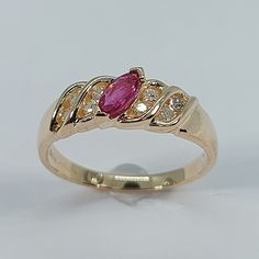 This stunning  style ring has been carefully crafted in warm 14K Yellow gold, authentic ruby and authentic white diamonds. Great for any occasion! Buy it for your-self or for someone you love! This stunning ring will make a beautiful special occasion/birthday gift. All of my jewelry is handmade from scratch and of high quality. Once ring has been mailed a tracking shipping number will be provided to you. Ring Measurements and Materials: Ring is size 6  but can be resized at no extra cost and wil Gold Marquise Ring With Birthstone, Gold Marquise Cut Rings With Accent Stones, Yellow Gold Marquise Cut Rings With Accent Stones, Marquise Cut Yellow Gold Rings With Accent Stones, Gold Marquise Ring With Accent Stones, 14k Gold Marquise Rings Hallmarked, Classic Pink Ring Stamped 14k, Yellow Gold Ruby Rings With Diamond Cut, Heirloom Style 14k Gold Rings With Accent Stones