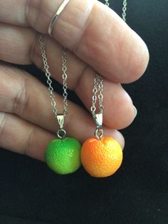 two small oranges are being held in the palm