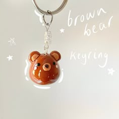 a brown bear keychain hanging from a metal ring