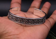 Vintage ethnic handmade solid silver bangle bracelet kada, antique hindi mantra " aum" design blessing jewelry from rajasthan india. Weight-37.020 grams. Width-13 mm. metal-sterling silver. metal purity-92.5% Type-bangle bracelet kada. Brand-Traditional-jewellery. length adjustable (open face bangle kada) Marking-925. condition- excellent, high polished , brand new. makes excellent gifting and collectible items. Spiritual Silver Bracelets For Diwali, Adjustable Sterling Silver Bracelets For Diwali, Adjustable Silver Bracelets For Festivals, Spiritual Sterling Silver Bracelet With Intricate Design, Adjustable Silver Bracelets For Diwali, Adjustable Spiritual Jewelry For Diwali, Adjustable Sterling Silver Bangle For Festivals, Adjustable Sterling Silver Cuff Bracelet For Festivals, Silver Symbolic Jewelry For Diwali