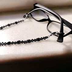 This handmade black crystal glasses chain is made from the highest quality glass beads, carefully hand-woven! It is not only a glasses chain, but also a multi-purpose chain that you can use as a stylish necklace wrap bracelet and goth style sunglasses chain! It is light! This way, your glasses will never be lost! Lenght 75 cm ( 29 inches ) Shiny glasses chain, compatible with all your clothes that you can use in all seasons, is the ideal handmade gift accessory and jewelry for you and your loved Metal Beaded Glasses Chains For Party, Beaded Metal Glasses Chains For Party, Black Glass Beaded Jewelry, Beaded Metal Glasses Chains As Gift, Elegant Black Glasses Chains For Party, Black Glass Jewelry For Jewelry Making, Metal Beaded Glasses Chains As Gift, Metal Beaded Glasses Chains For Gifts, Black Glass Glasses Chain For Parties