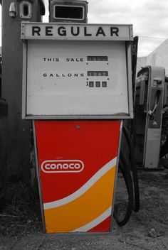 an old gas pump with the word regular written on it's front and side