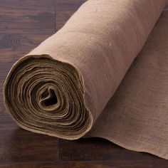 a roll of burlock on top of a wooden floor