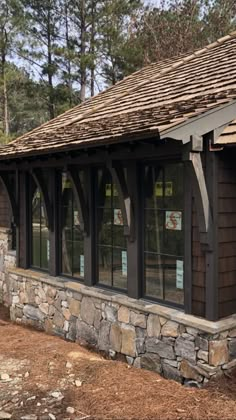 an image of a small building with windows and shingles on the side of it