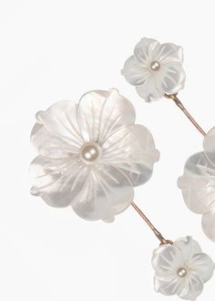 three white flower hair pins with pearls on them