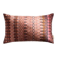 an orange and pink pillow with geometric designs