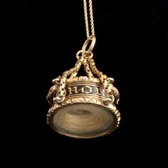 A classic, beautiful Georgian "In Memory Of" ring that was repurposed to make a locket - probably not long after it was originally made. The ring is affixed with lengths of chain to make into a pendant and has been set with glass panels that hold a lock of hair. Why was this ring modified? Perhaps its owner could no longer wear it on the hand but wanted to keep it close? We'll never know for sure. A cleverly constructed and very unusual piece. Heirloom Necklace With Detachable Pendant, Vintage Charm Pendant Jewelry Keepsake, Elegant Vintage Memorial Jewelry With Charm, Elegant Vintage Charm Jewelry For Memorial, Keepsake Vintage Charm Pendant Jewelry, Heirloom Memorial Pendant Necklace, Antique Yellow Gold Jewelry With Detachable Pendant, Timeless Hallmarked Medallion Jewelry, Heirloom 14k Gold Jewelry For Keepsake