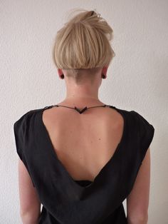 the back of a woman wearing a black dress