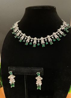 Beautiful and elegant Choker with high quality stones. Comes with a pair of matching earrings in silver and emerald finish. Can pair well with any outfit or dress for a night out! The green stone is amazing quality and is such a beautiful tone. Dazzling Green Emerald Necklace For Formal Occasions, Formal Green Emerald Diamond Necklace, Green Sparkling Stones Jewelry Sets For Party, Elegant Emerald Necklace With Stones For Formal Events, Formal Silver Jewelry Sets With Emerald, Green Crystal Jewelry Sets With Sparkling Stones, Green Emerald Jewelry With Sparkling Stones, Formal Silver Emerald Jewelry Sets, Dazzling Emerald Necklace For Formal Occasions