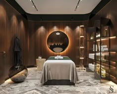 a spa room with a large round mirror on the wall