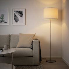 a living room with a couch, table and lamp