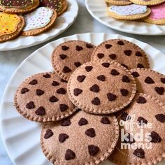 several plates with cookies on them sitting on a table