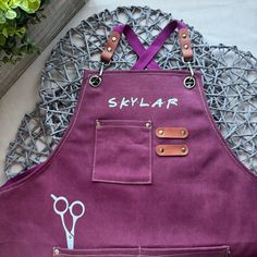 a pair of scissors sitting on top of a purple apron