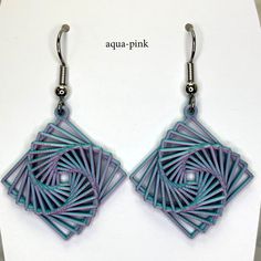 a pair of earrings that are made out of paper