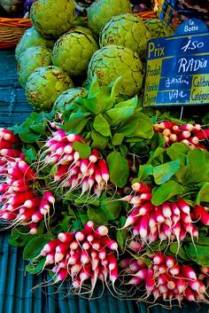 various vegetables and fruits on display at an outdoor market