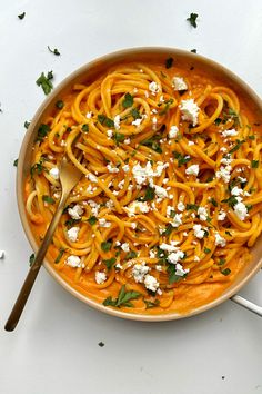 a bowl filled with pasta and feta cheese