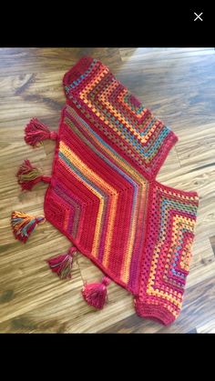 a crocheted bag sitting on top of a wooden floor