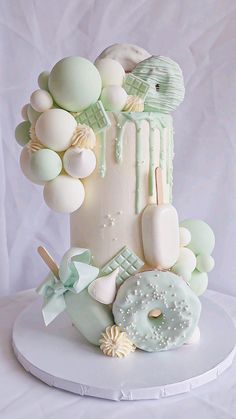 a white cake decorated with green and white decorations